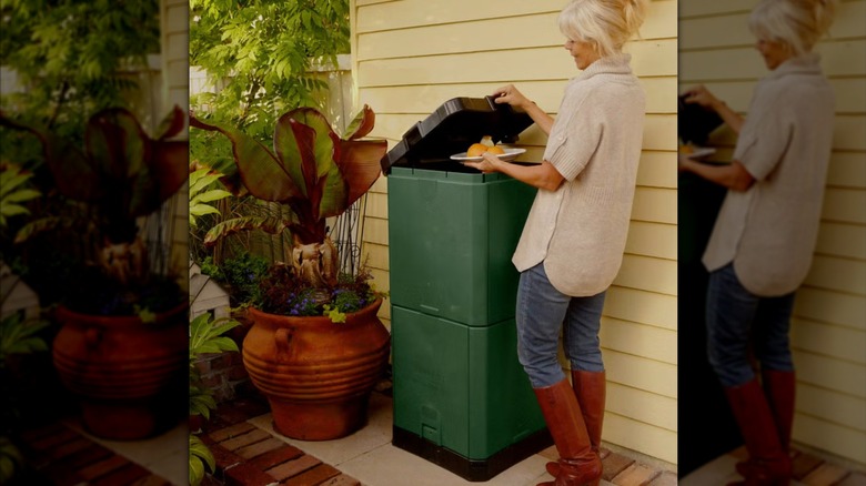 Woman adding food scraps to an Aerobin composter