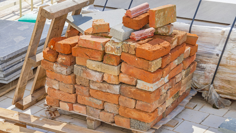 Stack of used bricks at pallet reclaimed building material.