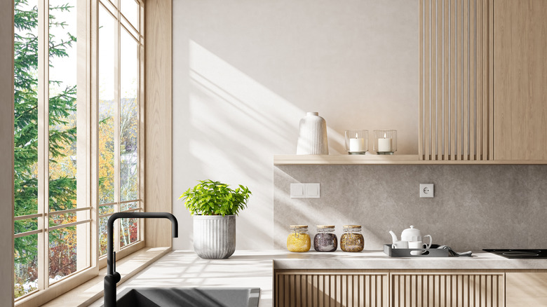 Kitchen window letting light through in modernist house
