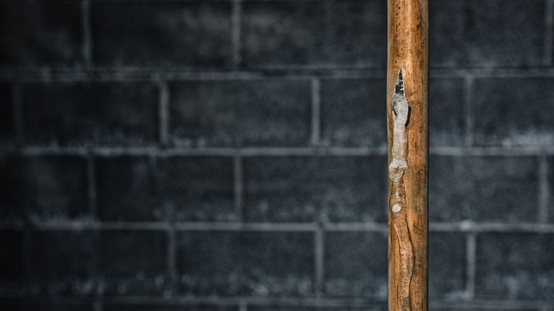 Vertical copper pipe that has burst with a trail of ice