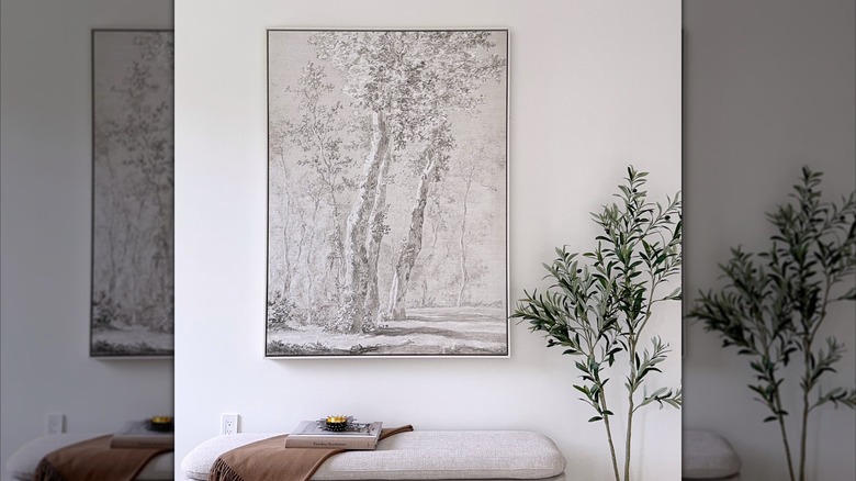 black and white nature-inspired art piece next to house plant