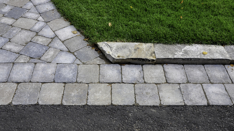 Natural stone curbing at the edge of a driveway