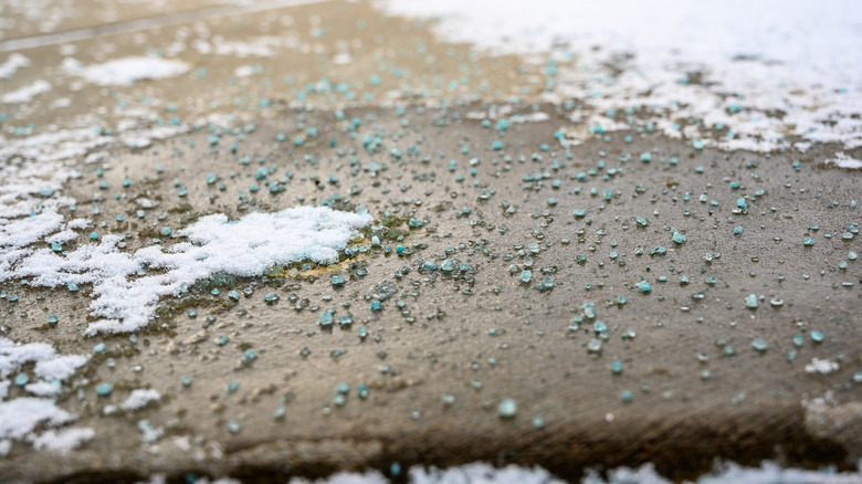 Rock salt and snow on driveway