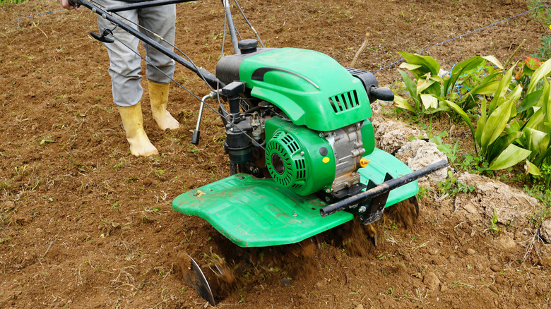 Man rototilling the garden