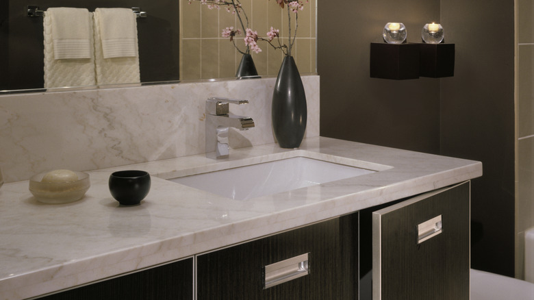 Black bathroom with white cabinets