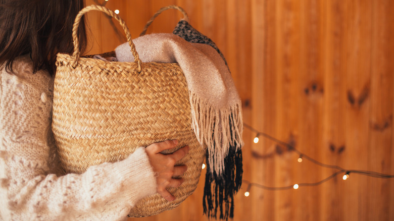 Person holding a basket with a blanket in it