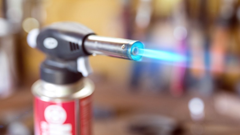 Butane torch blowing blue flame
