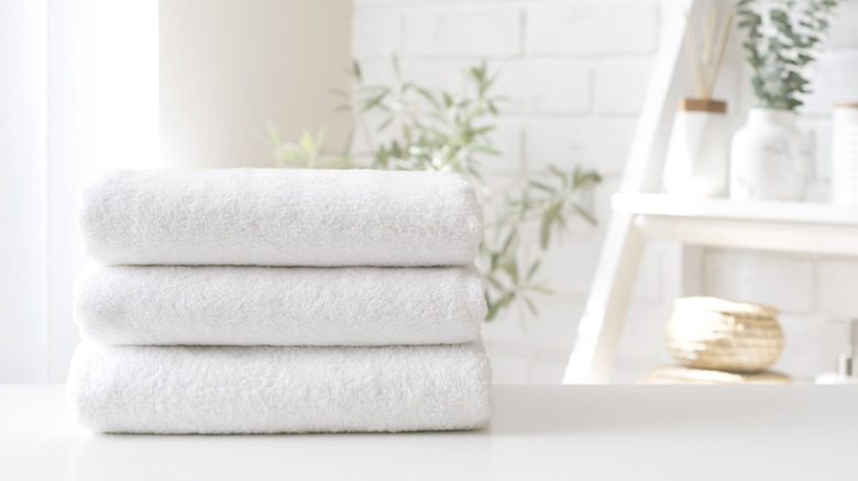A pile of crisp, white towels neatly stacked on top of a table