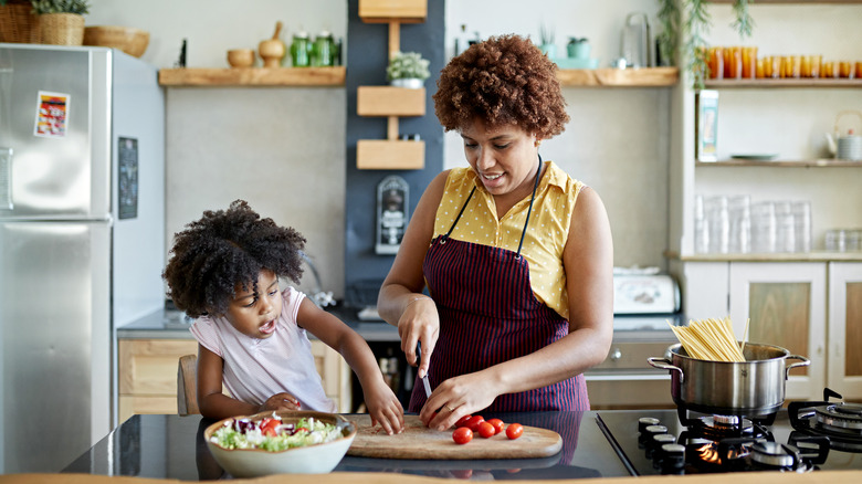 Mother and daughter cooking together