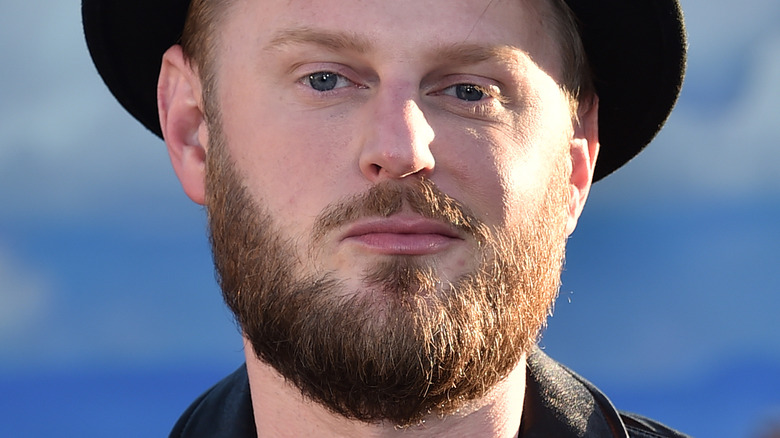 Bobby Berk smiling, wearing hat