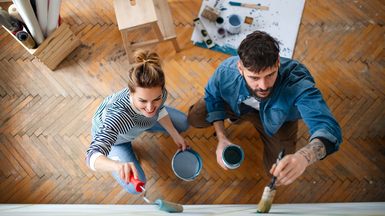 Couple painting wall