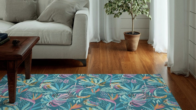 Tropical print area rug in a living room on a hard wood floor