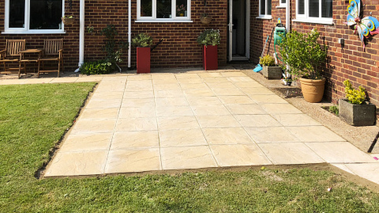 A stone patio in a backyard
