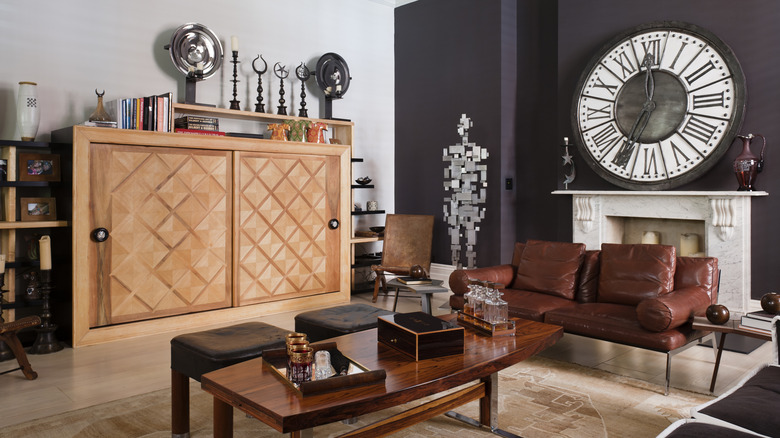 Room with dark gray accent wall and wood accents
