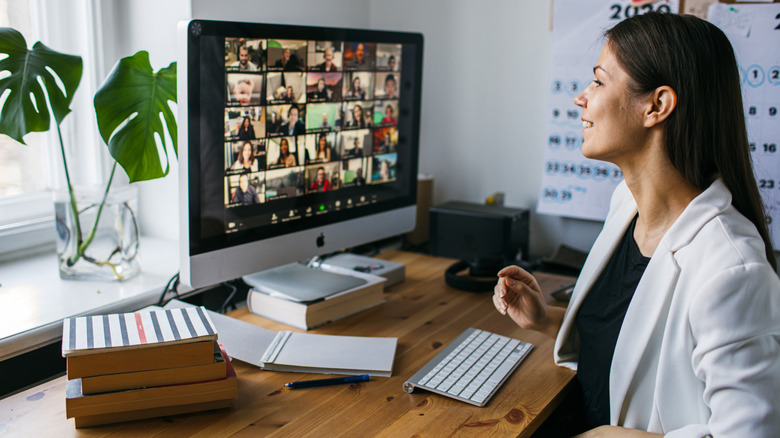 A woman on a zoom call at her home desk.