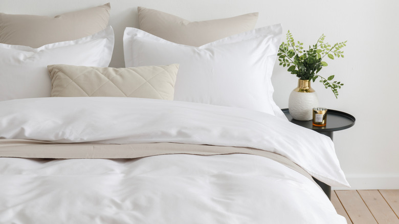 A bed made up with a duvet cover and lots of pillows