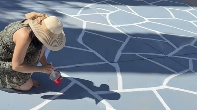 Adding crisp white 'rock' lines to enhance the driveway