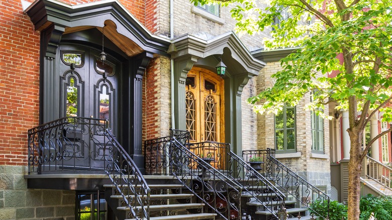 Heritage doors on two brick row houses side by side.