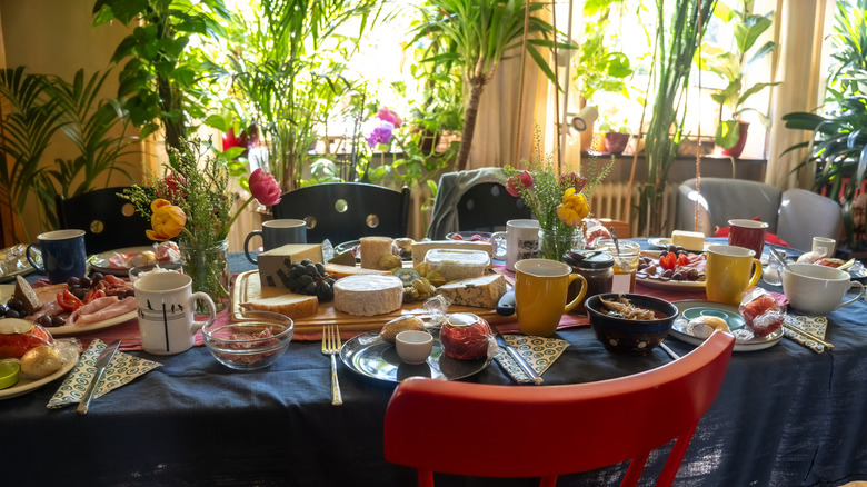 Large dining table with colorful crockery