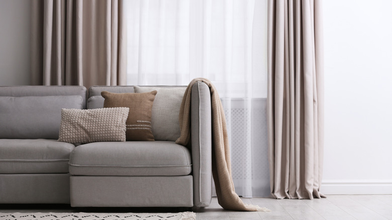 Modern living room interior with beautiful curtains on window.