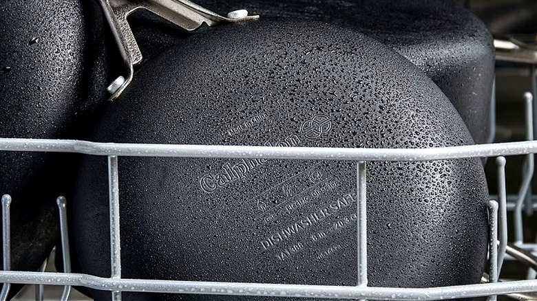 Close-up of a black nonstick frying pan in a dishwasher