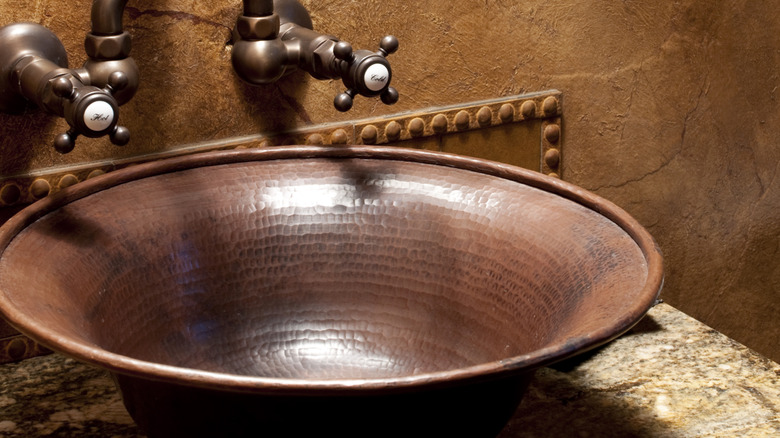 close up of aged copper sink basin