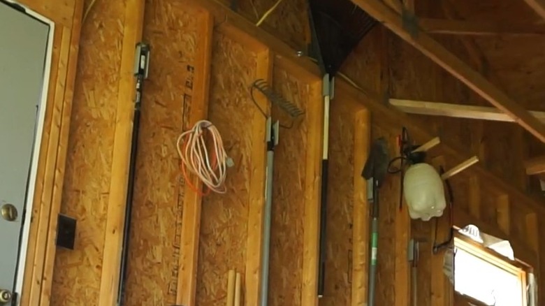 tools hanging on cut PVC pipes