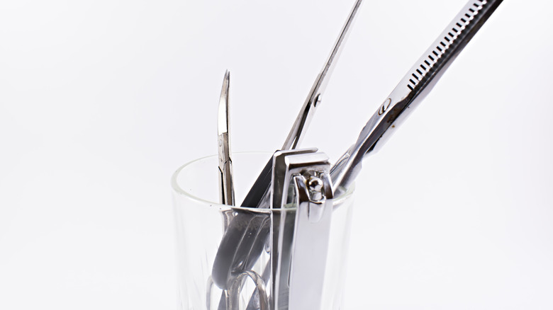 Shot glass with nail clippers