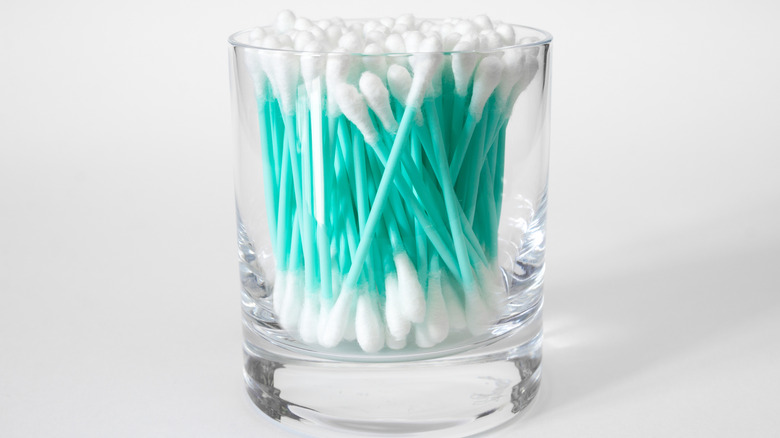 Q-tips in shot glass