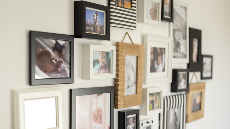 gallery wall in home with couple photos and baby images