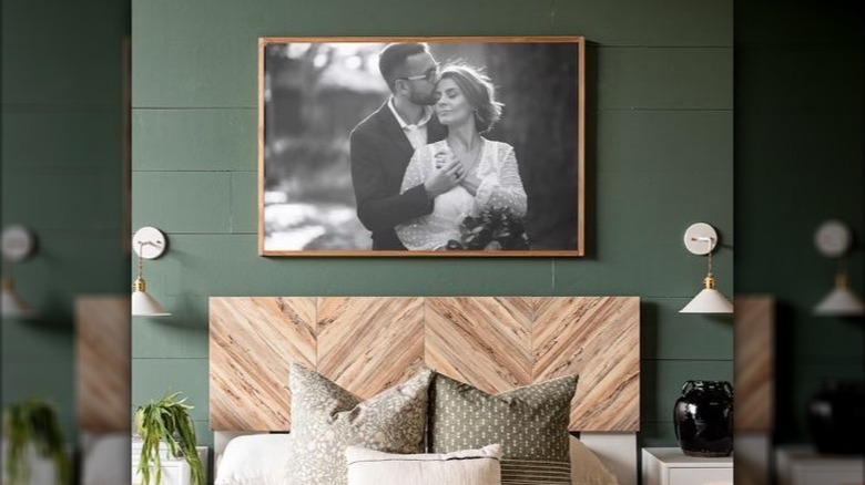 framed wedding photo above bed