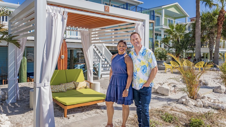 Brian and Mika Kleinschmidt in front of beachfront hotel