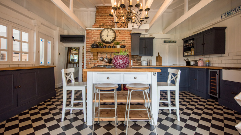 Kitchen with tile floor, brick wall, and blue cabinets