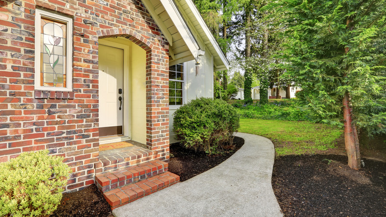 house with brick entryway and concrete walkway