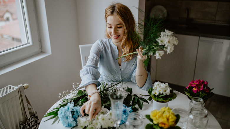 woman arranging flower displays