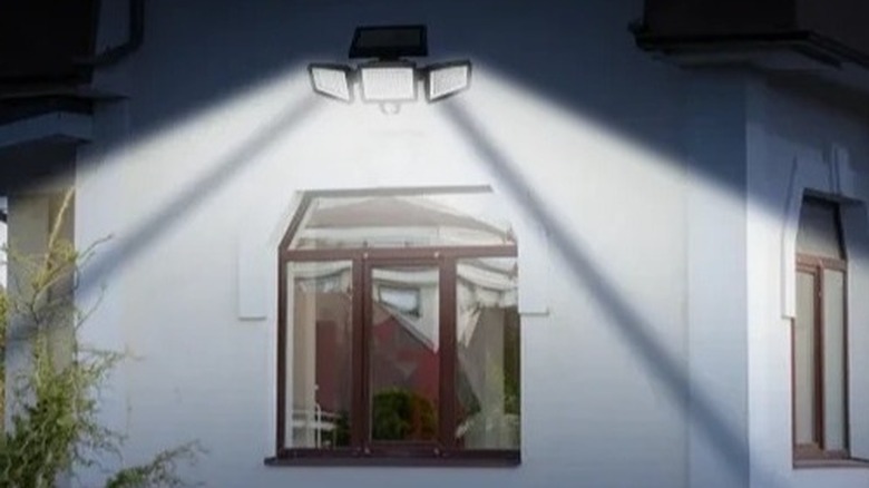 A flood light illuminating a backyard