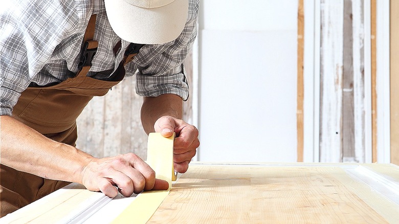 Person taping with masking tape