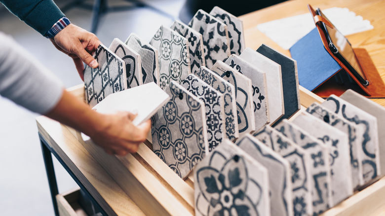 Hands touching patterned hexagon tiles