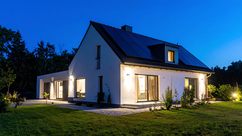 A home with bright exterior lights at night