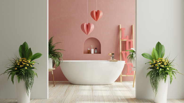 hanging hearts above a bath and a sign that says love
