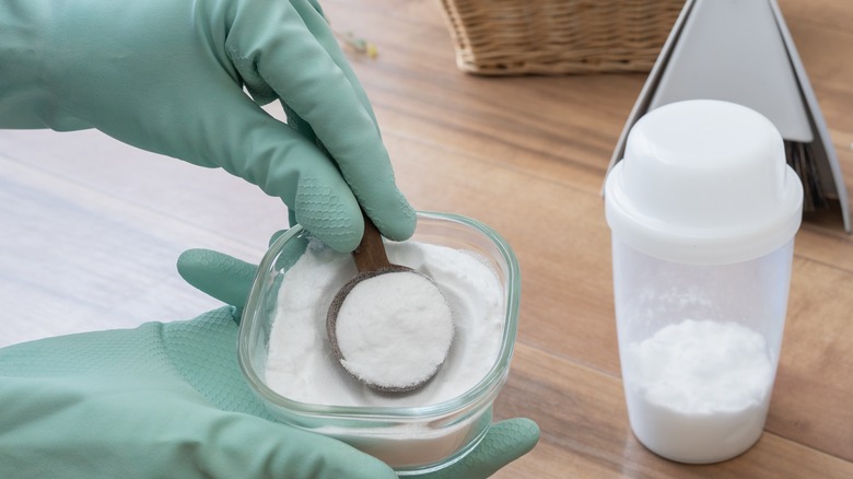 person scooping cream of tartar 