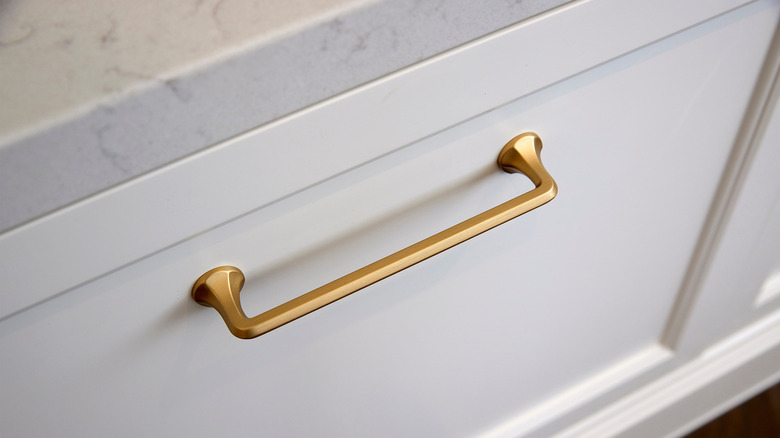 a brushed brass cabinet pull