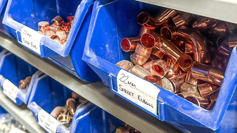spare copper fittings organized in work shop bins