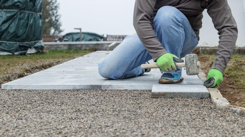 Person installing a paver path