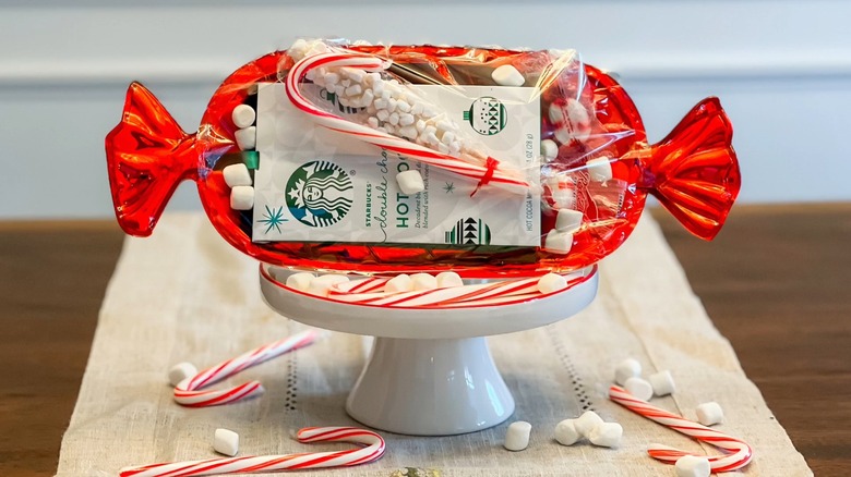 A hot cocoa packet wrapped with marshmallows on a white dish
