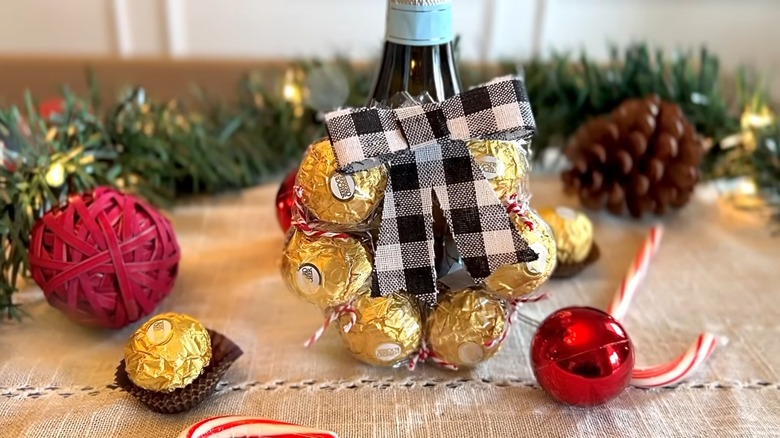 A chocolate wreath with a bow and wine bottle
