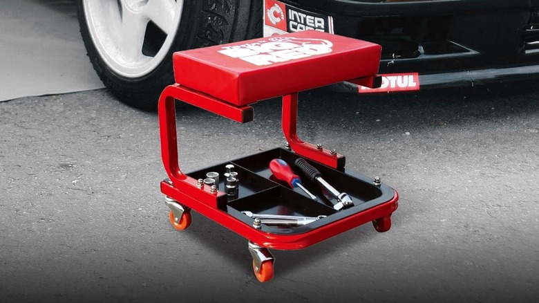 Torin TR6300 Red Rolling Creeper Garage Seat beside car