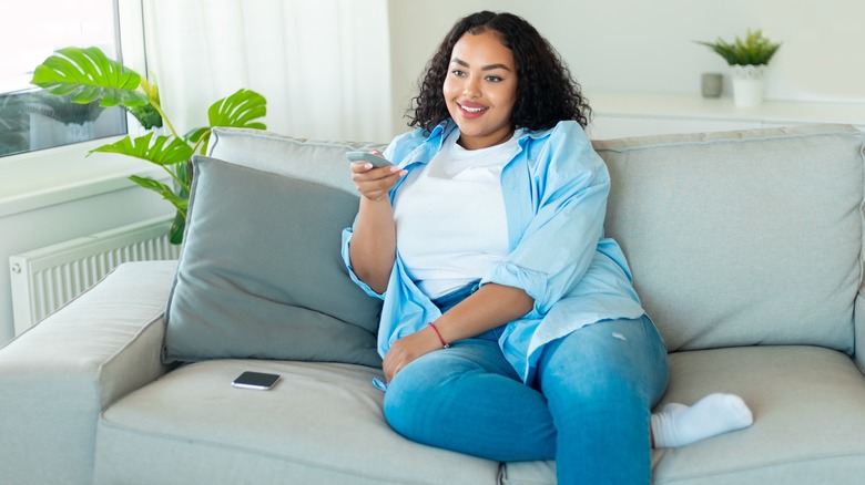 Plus-size woman sitting on sofa