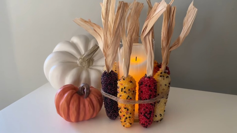 Colorful corn cobs tied around a LED candle