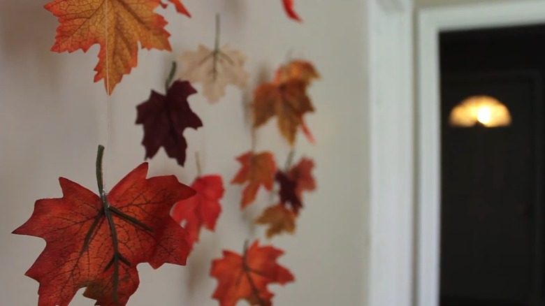 Fall leaves hanging on strings near doorway